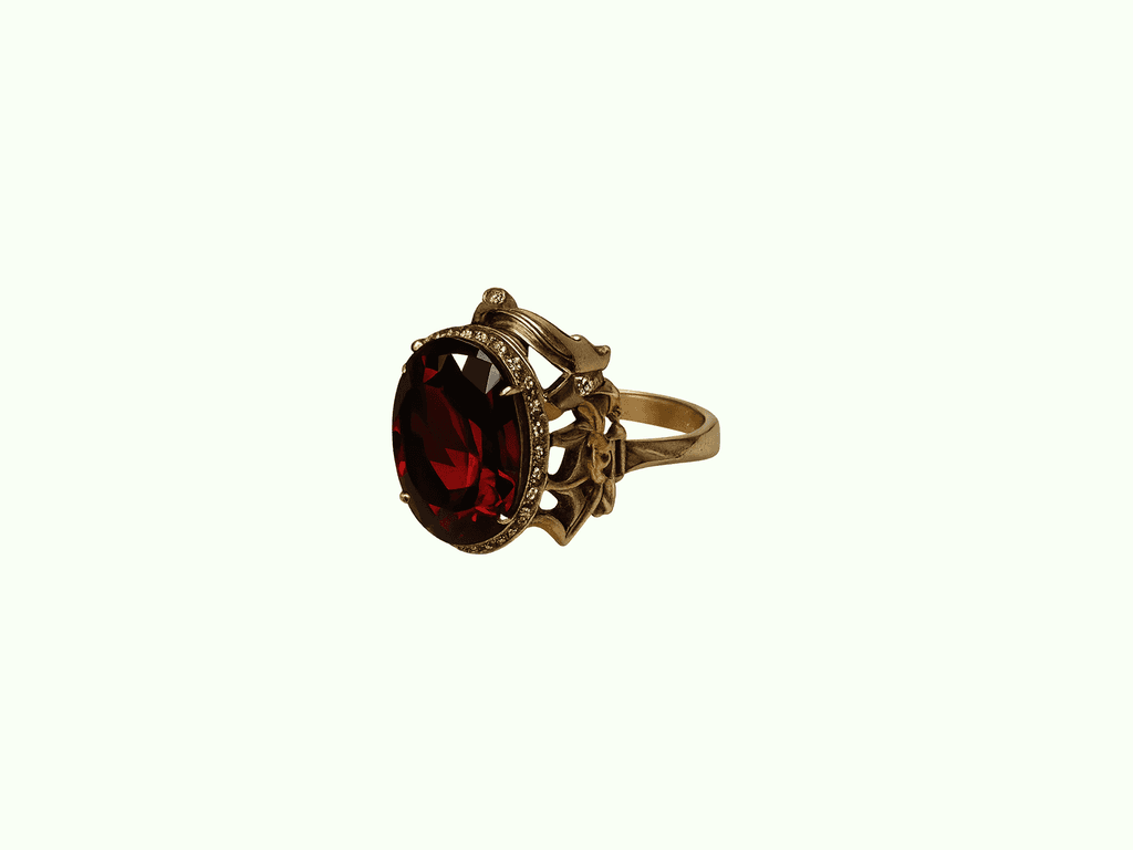 Garnet Sovereign Ring — ornate gold ring with garnet stone